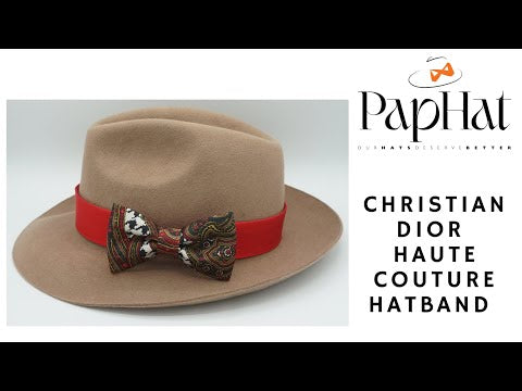 Watch a video demonstration of transforming a Christian Dior vintage scarf into an exquisite haute couture hatband. Witness the meticulous craftsmanship and sustainable fashion behind this unique accessory